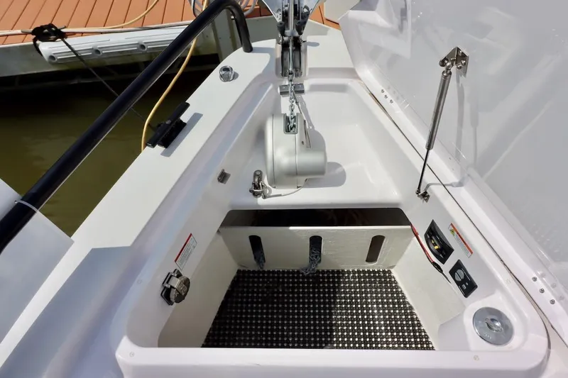 Slide: The Image of Anchor compartment of 2022 Axopar 37 XC Cross Cabin boat, featuring winch and storage. - 41