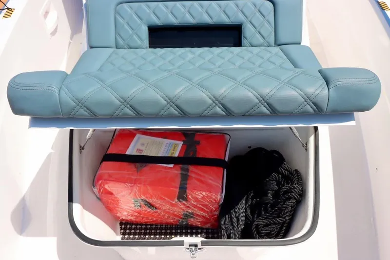 Slide: The Image of 2022 Axopar 37 XC Cross Cabin seat storage with life jacket and rope. - 42