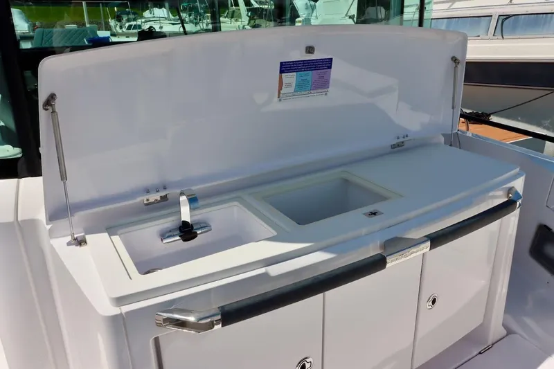 Slide: The Image of 2022 Axopar 37 XC Cross Cabin boat sink and storage area. - 46