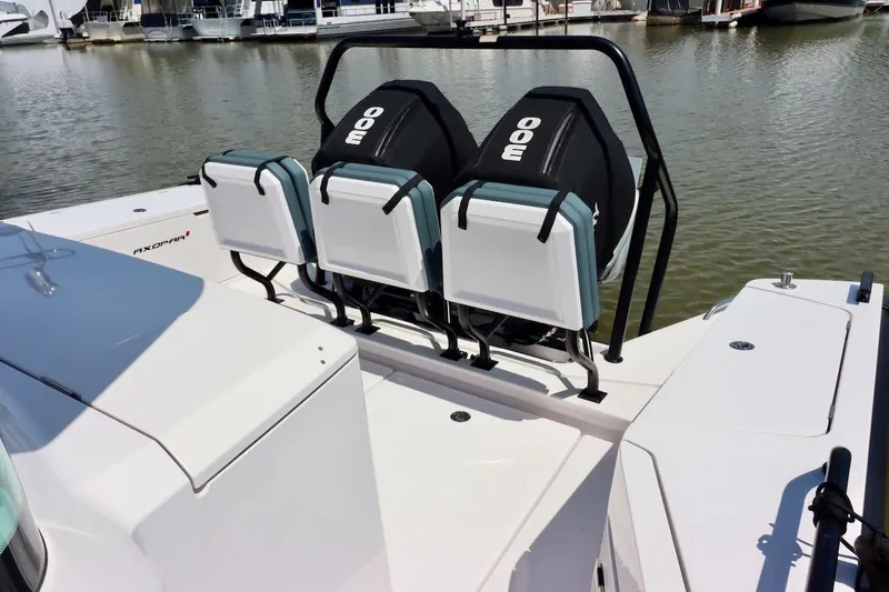 Slide: The Image of 2022 Axopar 37 XC Cross Cabin boat with rear seating, docked at a marina. - 49