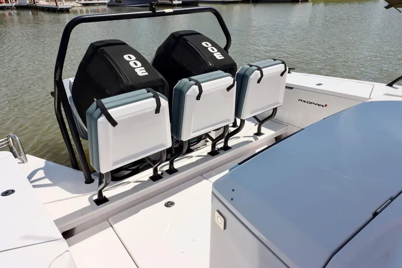 Slide: The Image of 2022 Axopar 37 XC Cross Cabin with triple outboard engines on a calm waterway. - 50