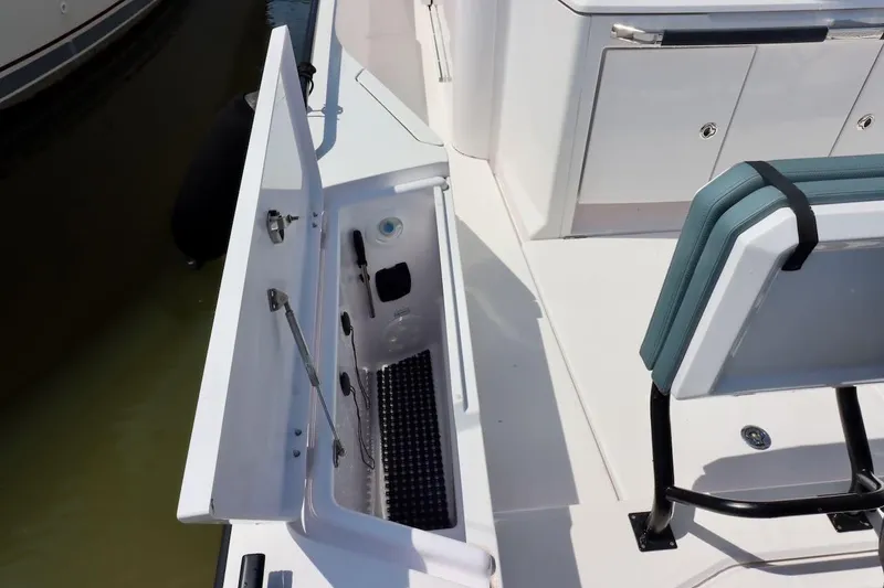 Slide: The Image of 2022 Axopar 37 XC Cross Cabin boat interior with open storage compartment. - 52