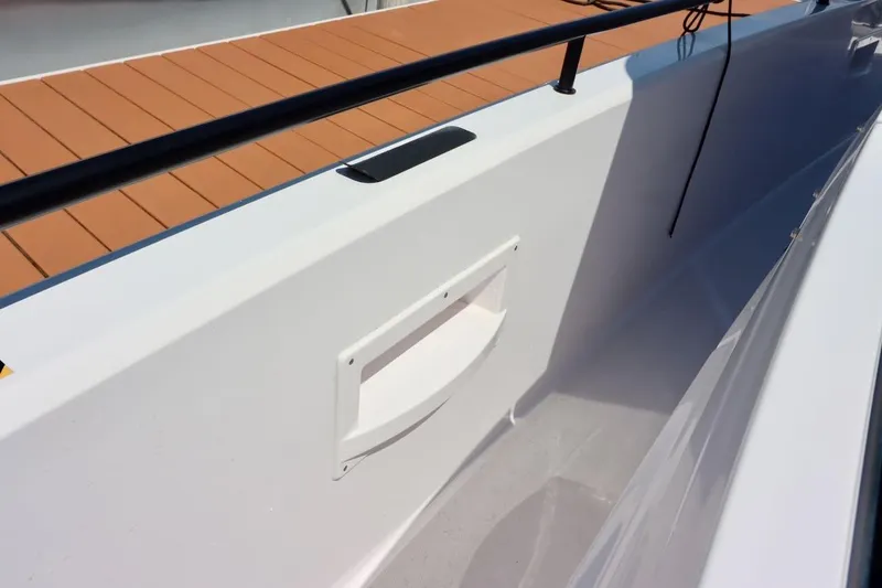 Slide: The Image of 2022 Axopar 37 XC Cross Cabin deck detail with sleek white and wood finish. - 55