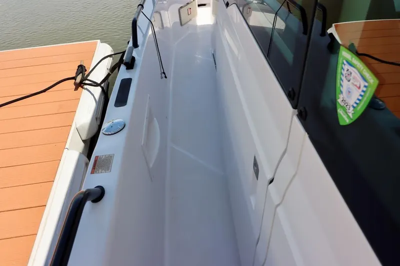 Slide: The Image of 2022 Axopar 37 XC Cross Cabin docked, showcasing sleek white exterior and modern design. - 56