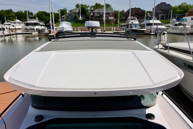 Slide: The Image of 2022 Axopar 37 XC Cross Cabin docked at a marina, showcasing its sleek design. - 57