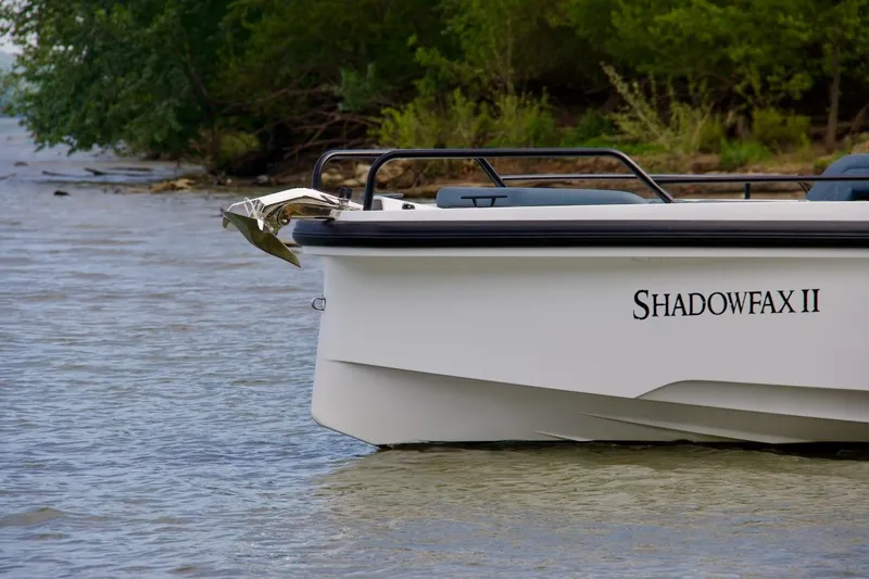 Slide: The Image of 2022 Axopar 37 XC Cross Cabin boat named Shadowfax II on calm water. - 7
