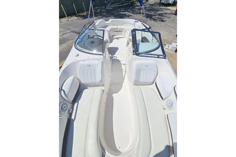 Slide: The Image of 2006 Regal 2400 Bowrider boat with open cabin and seating. - 10