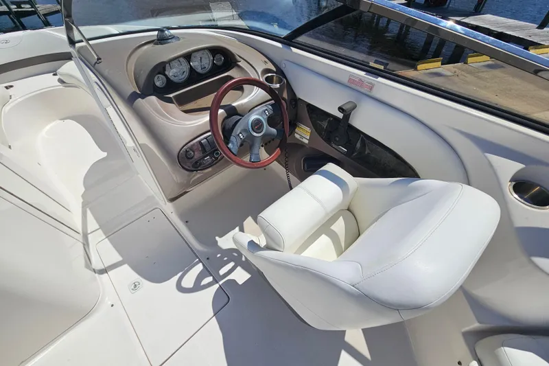 Slide: The Image of Interior of a 2006 Regal 2400 Bowrider boat with steering console. - 13