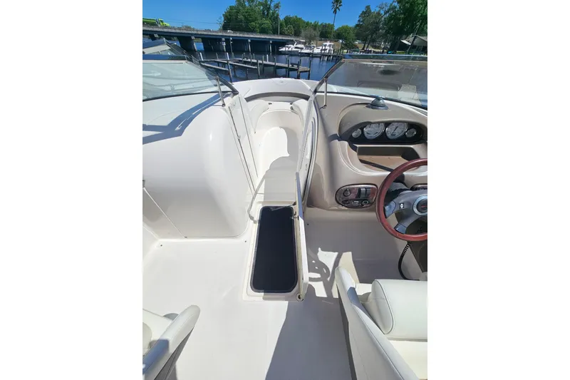 Slide: The Image of Interior of a 2006 Regal 2400 Bowrider boat, featuring helm and seating area. - 15