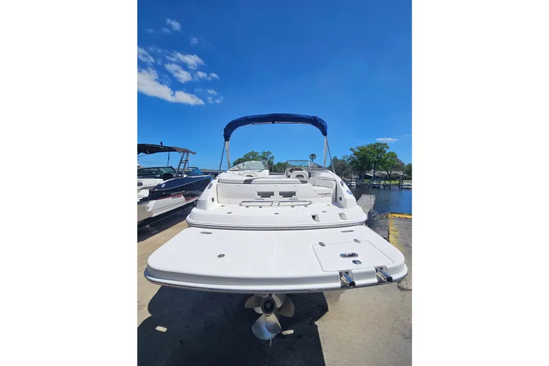 Slide: The Image of 2006 Regal 2400 Bowrider boat docked under sunny skies. - 4