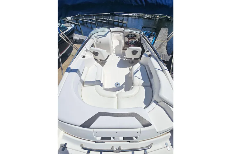 Slide: The Image of 2006 Regal 2400 Bowrider boat with white interior at dock. - 8