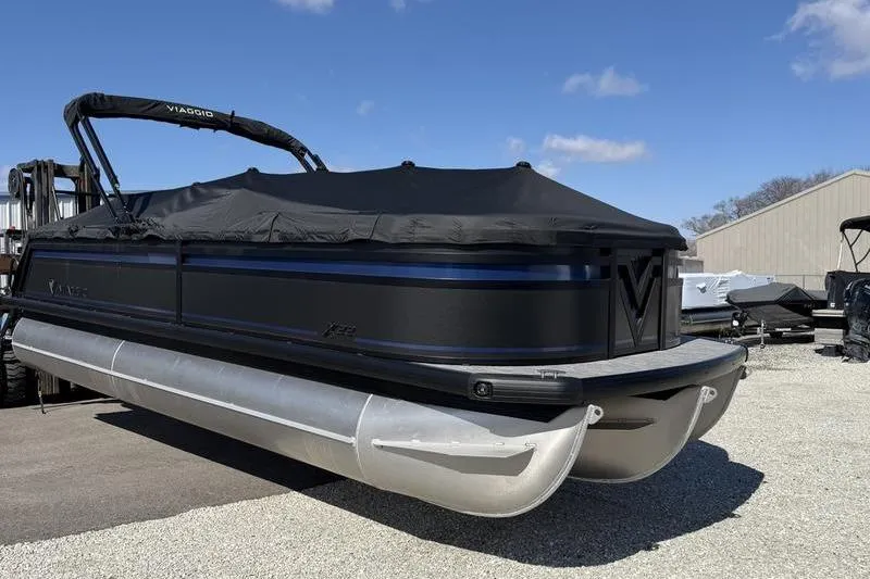 The Image of Viaggio X22Q 2026 pontoon boat with cover on gravel surface. - 0