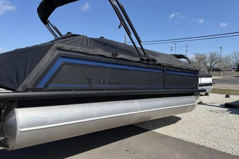 Slide: The Image of Viaggio X22Q pontoon boat 2026 with cover on parking lot. - 2