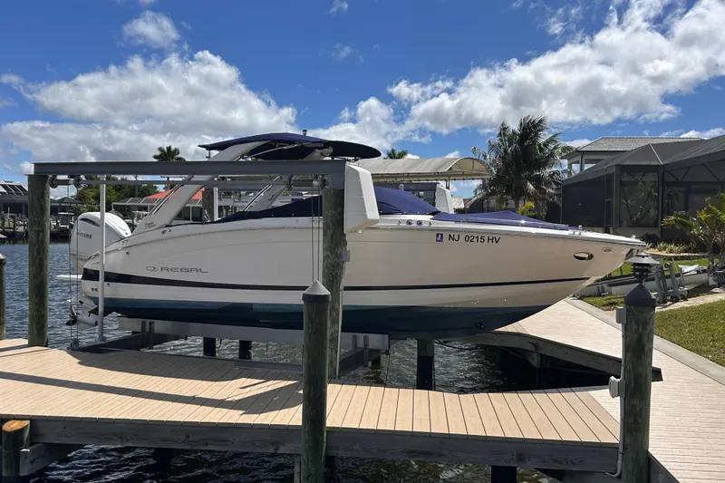 The Image of 2025 Regal LX6 boat on a dock under sunny skies. - 0