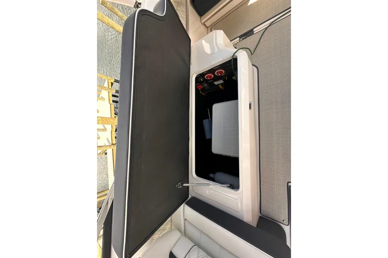 Slide: The Image of Regal LX6 2025 boat storage compartment with open lid. - 18