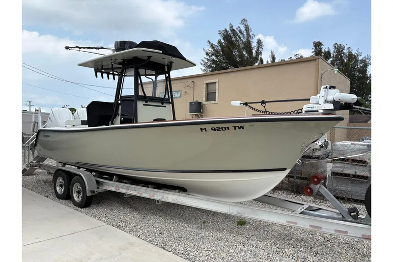 The Image of 2025 Stuart 27 boat on trailer, parked outdoors, with overcast sky. - 0