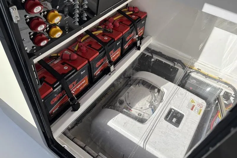 Slide: The Image of Battery compartment of a 2025 Stuart 27 with multiple batteries. - 13