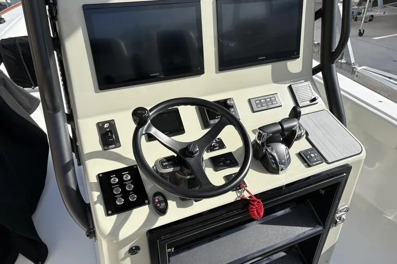 Slide: The Image of Stuart 27 boat helm, 2025 model, featuring modern controls and displays. - 29