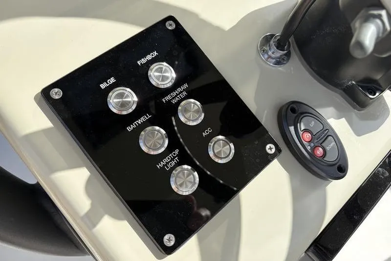 Slide: The Image of Control panel of a 2025 Stuart 27 boat model with various switches. - 30