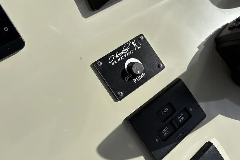 Slide: The Image of Stuart 27 2025 boat control panel with Hooker Electric pump switch. - 33