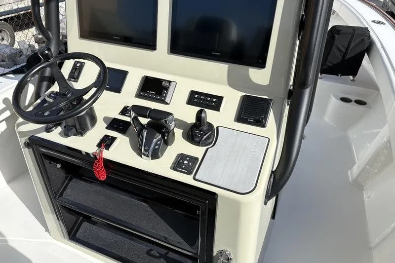 Slide: The Image of 2025 Stuart 27 boat helm with modern electronics and controls. - 36