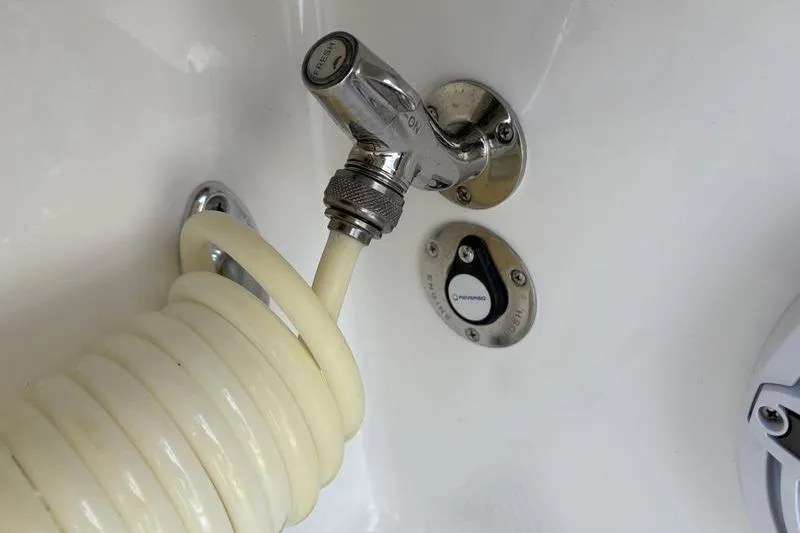 Slide: The Image of Stuart 27 boat 2025: Close-up of faucet with hose. - 38