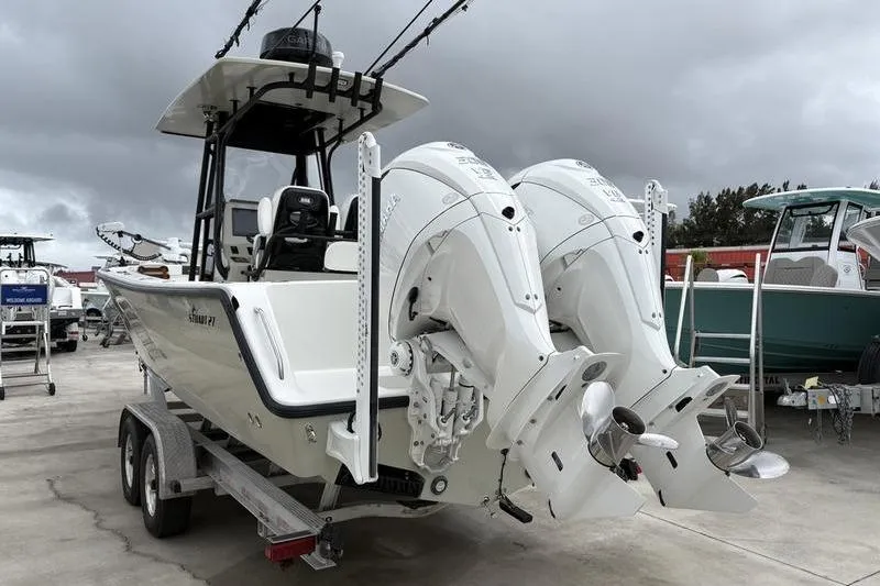 Slide: The Image of Stuart 27 boat 2025 with dual outboard engines on trailer. - 4