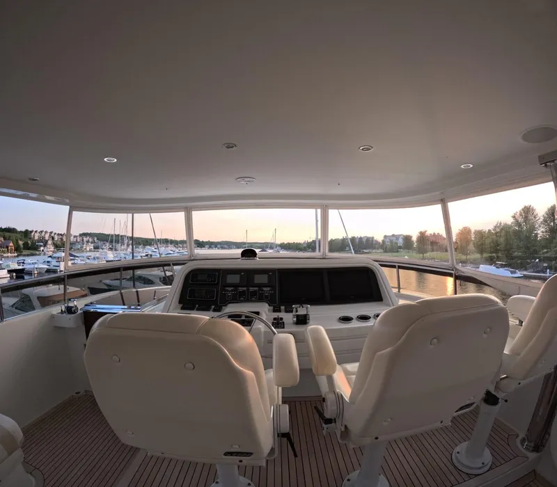 Slide: The Image of Interior view of 2007 Hargrave 93' yacht helm with sunset marina backdrop. - 13
