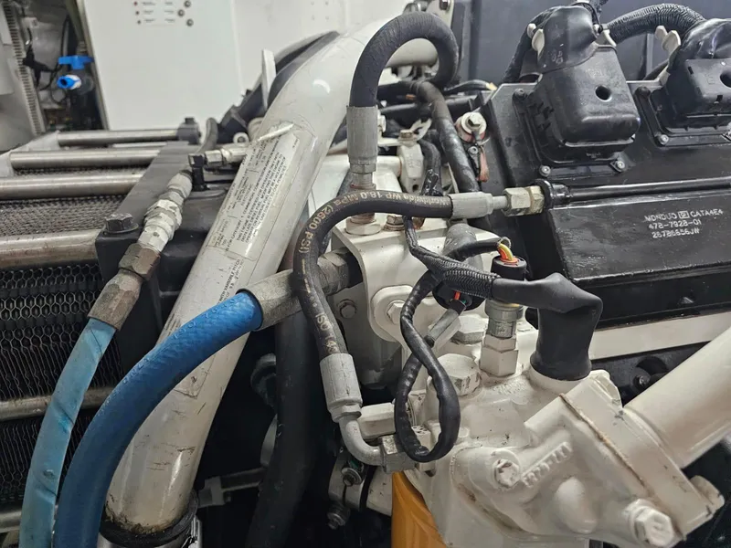 Slide: The Image of Engine components of a 2007 Hargrave 93' yacht, featuring hoses and mechanical parts. - 39