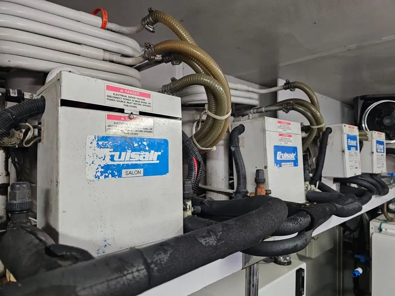 Slide: The Image of Engine room equipment on a 2007 Hargrave 93' yacht, featuring multiple units and piping. - 40