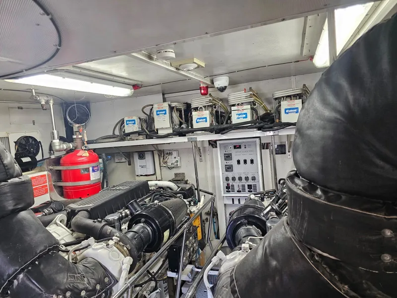 Slide: The Image of Engine room of 2007 Hargrave 93' yacht, featuring machinery and control panels. - 41