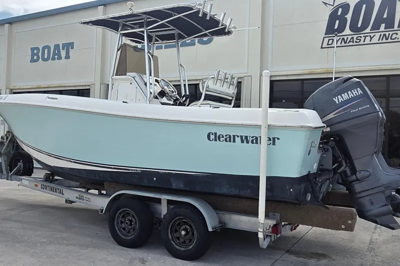 Slide: The Image of 2008 Clearwater 2300 Center Console boat on trailer outside store. - 2