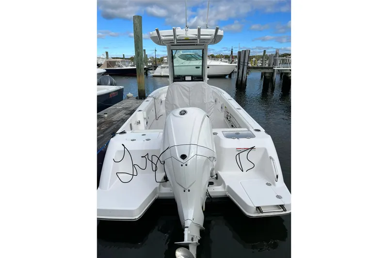 Slide: The Image of 2023 Everglades 235 Center Console boat docked at marina. - 2