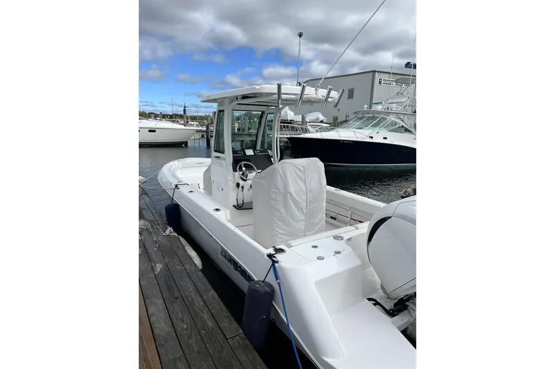 Slide: The Image of 2023 Everglades 235 Center Console boat docked at marina. - 3
