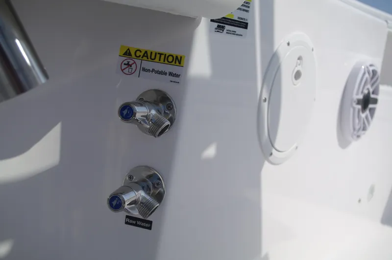 Slide: The Image of Everglades 235 Center Console 2023, water connections and caution sign. - 35