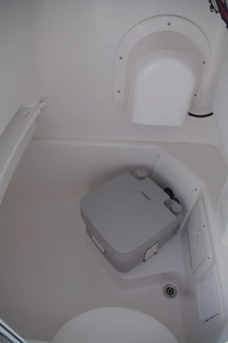 Slide: The Image of Interior of Everglades 235 Center Console 2023 with portable toilet. - 36