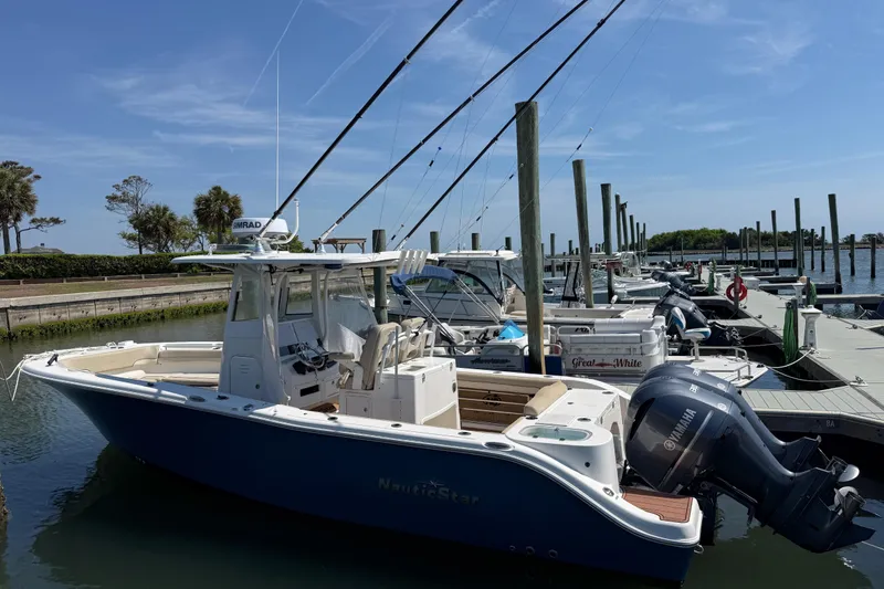 Slide: The Image of 2021 NauticStar 28 XS boat docked at marina. - 11