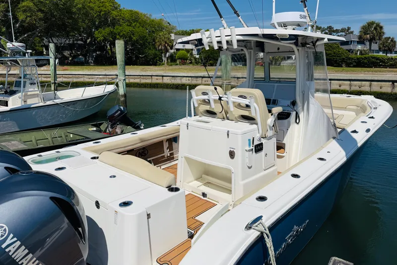 Slide: The Image of 2021 NauticStar 28 XS boat docked with Yamaha engines. - 12