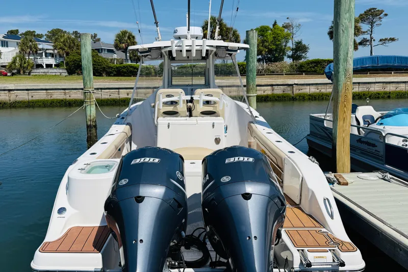 Slide: The Image of 2021 NauticStar 28 XS boat with twin outboard engines at dock. - 13