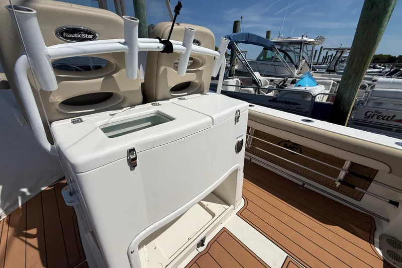 Slide: The Image of NauticStar 28 XS 2021 boat with rod holders and storage. - 6