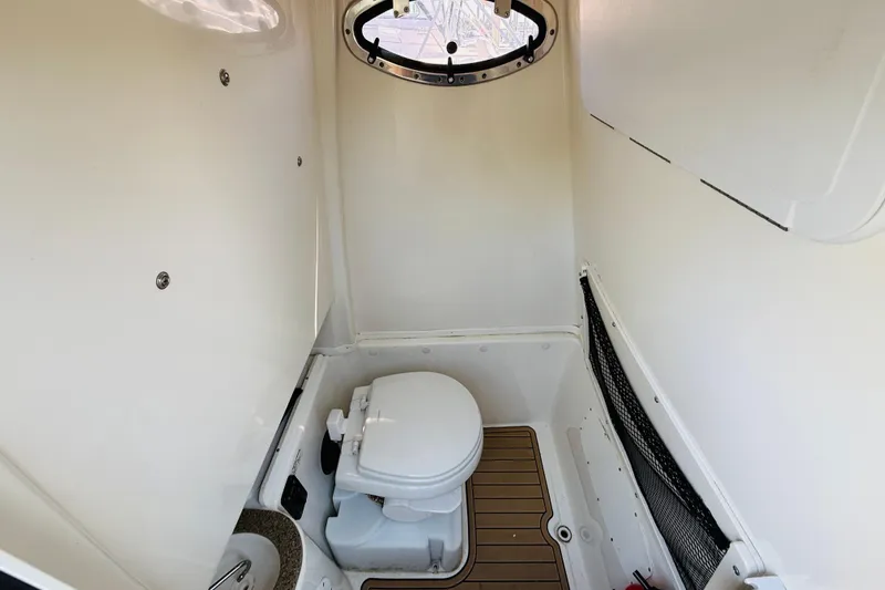 Slide: The Image of Interior of 2021 NauticStar 28 XS featuring toilet and window. - 9