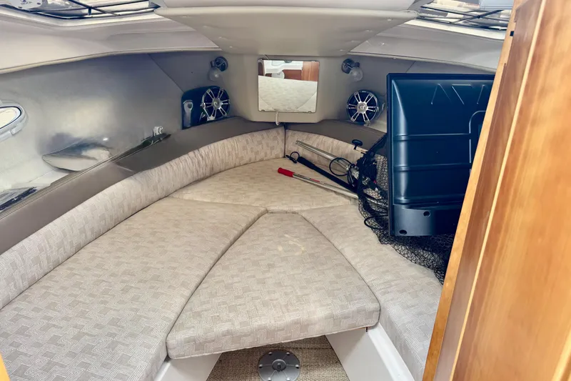 Slide: The Image of 2022 Cutwater boat interior with cushioned seating and fishing gear. - 2