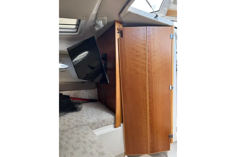 Slide: The Image of Interior of 2022 Cutwater boat with TV and wooden cabinet. - 4