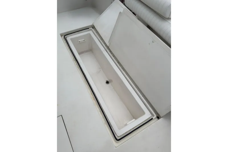 Slide: The Image of Open storage compartment on 2004 Topaz 32 Express boat, showcasing interior space. - 14