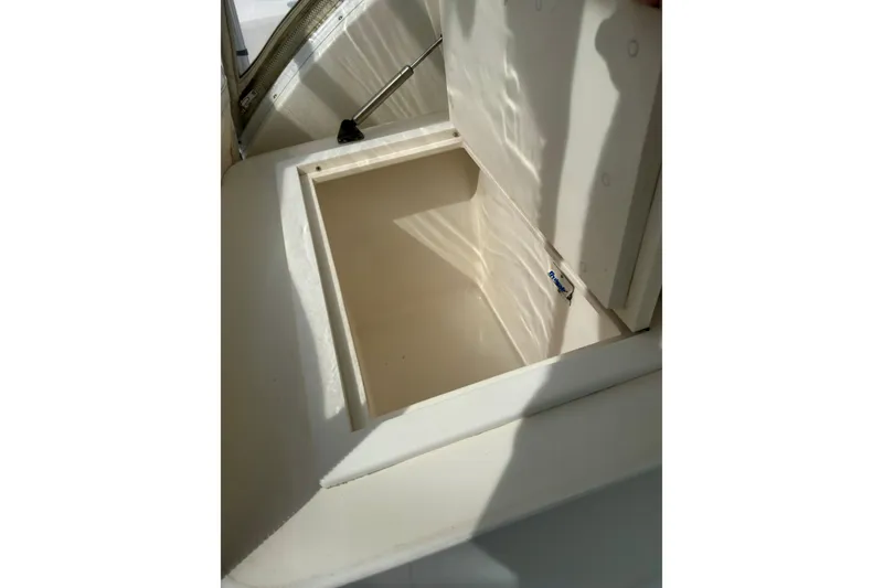 Slide: The Image of Open storage compartment on a 2004 Topaz 32 Express boat. - 15