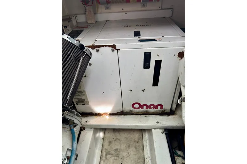 Slide: The Image of Onan generator in a 2004 Topaz 32 Express boat engine compartment. - 23