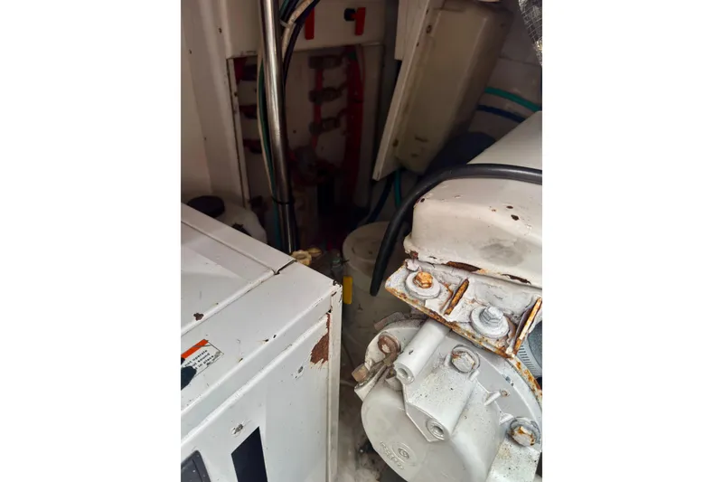 Slide: The Image of Engine room of a 2004 Topaz 32 Express boat, showing mechanical components and wiring. - 24