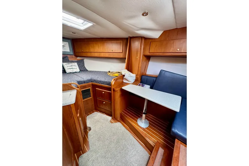 Slide: The Image of Interior of 2004 Topaz 32 Express boat with wooden cabinetry and seating area. - 28