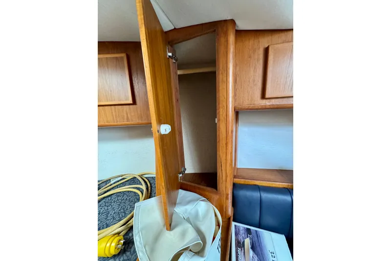 Slide: The Image of Wooden cabinet interior on a 2004 Topaz 32 Express boat. - 30
