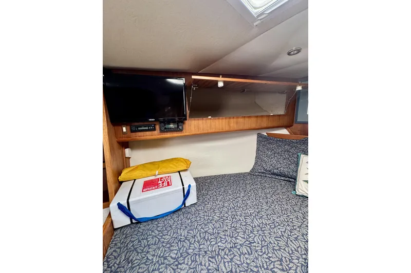 Slide: The Image of Interior cabin of 2004 Topaz 32 Express with bed, TV, and life raft. - 31